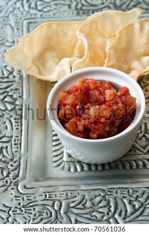 Pappadams and pineapple chutney which often belong to an Indian menu.