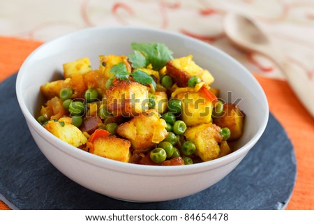 Image of mattar paneer, an Indian vegetarian dish with  paneer and peas in a spicy sauce.