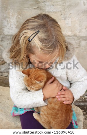 5 year old girl holding a cat