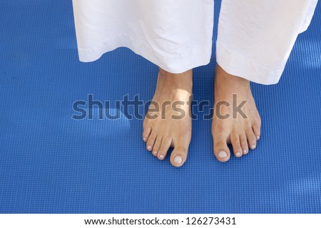 A womans feet on a training carpet. Space for text