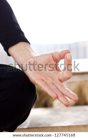Yoga hand in gyan mudra position. Vertical, Space for text