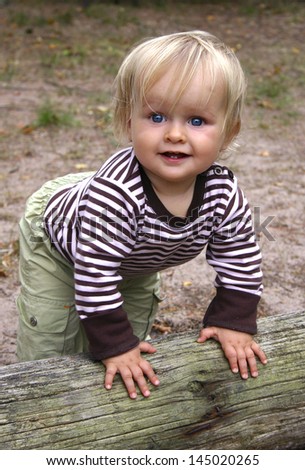 A happy toddler wants to stand up and start to walk. Vertical. Happy feeling