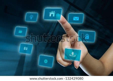 a woman finger in selection a folder on a digital screen