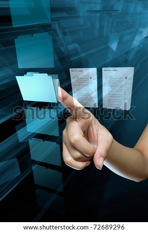 a woman hand choice a folder on a computer screen