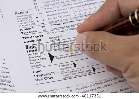 Businessman filling out tax form.