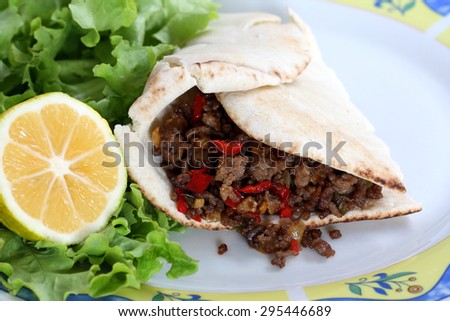 healthy eating: grilled beef taco with vegetables, salad and lemon