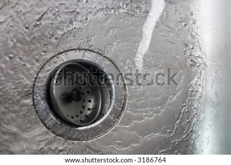 stock-photo-water-pouring-inside-kitchen-sink-and-flowing-down-drain-3186764.jpg