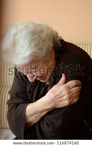 happy senior woman hugging herself