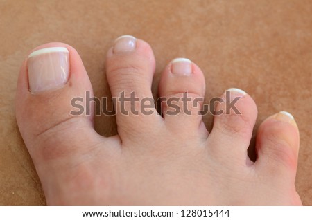 Single well-groomed female foot with a french pedicure.