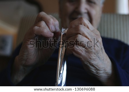 hands of a senior person opening a package