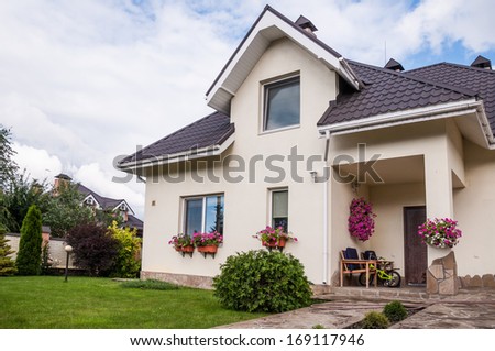 A new house with a garden in a rural area under beautiful sky A new house with a garden in a rural area under beautiful sky