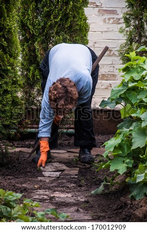 an old lady gardener working on garden