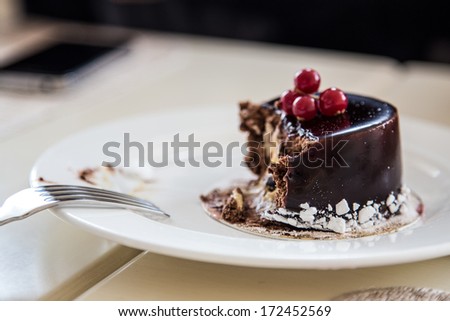 bitten (eaten) chocolate cake on plate