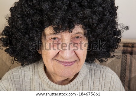 funny senior woman wearing wig