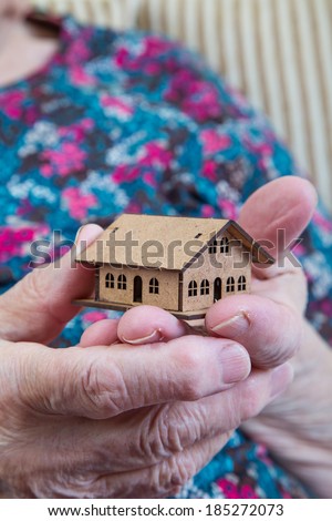 holding a small house
