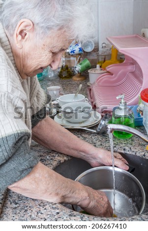 senior woman washing dishes
