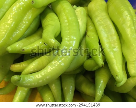 green banana peppers as a background