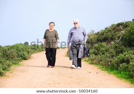 old people walking on a path
