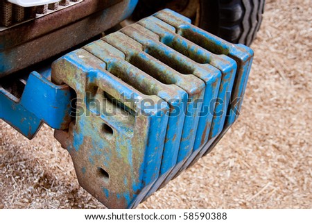 Agricultural Tractor front Balance Weights Blue with Wood Chip Backround
