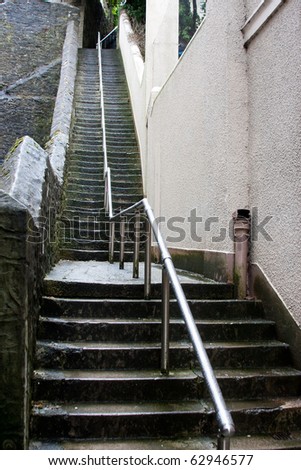 Abstract Tall Slippery Stone Steps with Shiny Steel Hand Rail