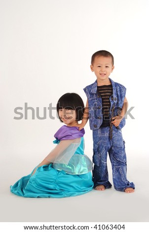 A little asian girl and boy with cute and happy facial expression in white background and having great fun.