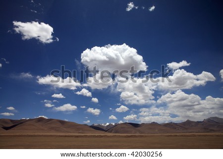 The white clouds floating in the blue sky of Tibet plateau, China.
