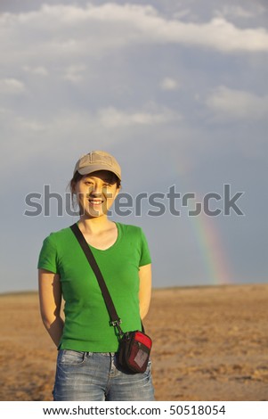 A young asian lady in the desert with rainbow