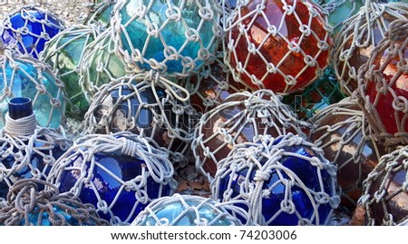 Colorful glass fishing floats with netting. Glass floats provided buoyancy, but were sometimes lost and washed ashore.