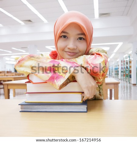 Portrait of muslim girl in library
