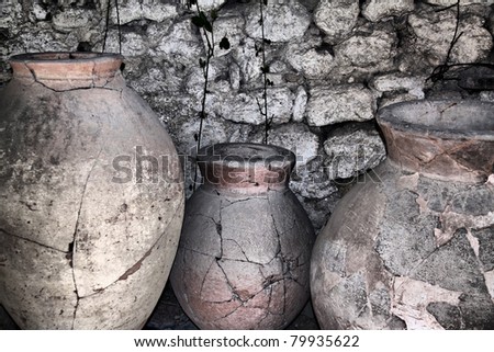 ancient ceramic pitchers at the wall