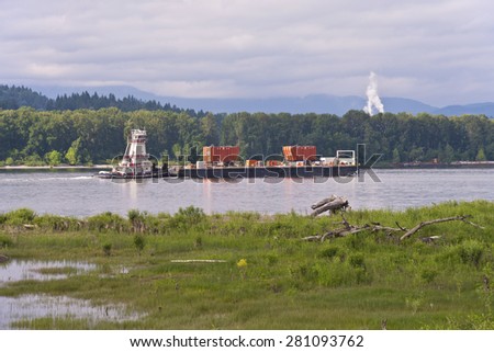 Pushing a barge with heavy load on the Columbia river Oregon.