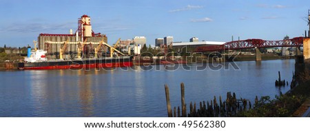 Grain elevators & cargo ship panorama.