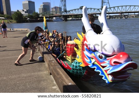 PORTLAND - JUNE 12: Dragon boat races on the Willamette river June 12, 2010 in Portland Oregon. Crew excited before take off.