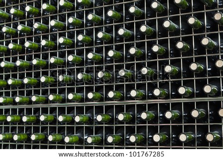 Shelf with bottles of red wine