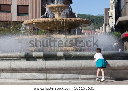 Children cooling off in the fountain in summer