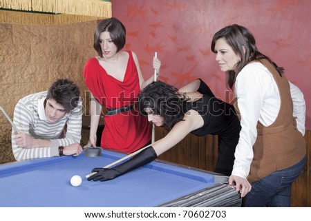 group of young people playing pool