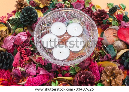 centerpiece with candles surrounded by flowers and aromatic dried pineapples