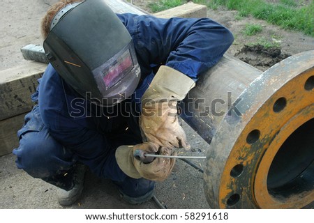 Welder welding a pipe