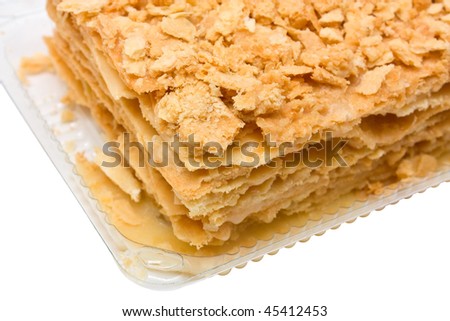 Closeup of tasty cake in plastic box. Isolated, shallow DOF.