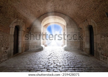 There is the light sky in the end of arch in a tunnel
