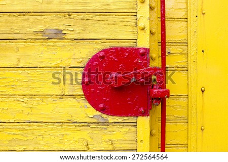 old french train yellow door and part of red door bolt close up as background