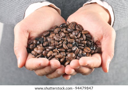 lots of coffee beans in the hand