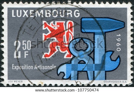 LUXEMBOURG - CIRCA 1960: A stamp printed in Luxembourg, is dedicated to the National Exhibition of Craftsmanship, Luxembourg-Limpertsberg, shows Heraldic Lion and Tools, circa 1960