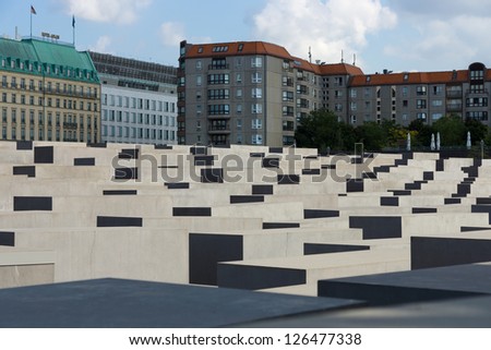 BERLIN - AUGUST 04: Memorial to the Murdered Jews of Europe; in the background; five-star Hotel Adlon; on August 04; 2012; Berlin; Germany