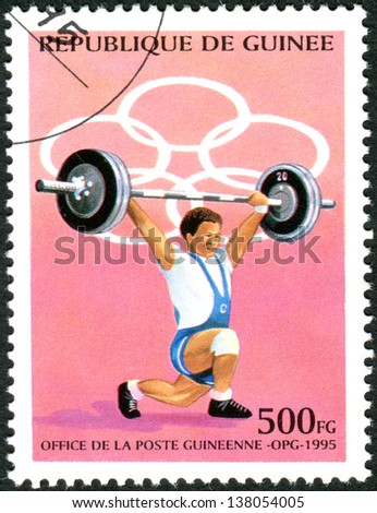 GUINEA - CIRCA 1995: A stamp printed in Guinea, devoted Summer Olympic Games in Atlanta, shows weightlifter, circa 1995