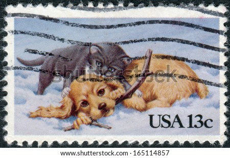 USA - CIRCA 1982: A postage stamp printed in USA, Christmas Issue, shows cat and dog playing in the snow, circa 1982