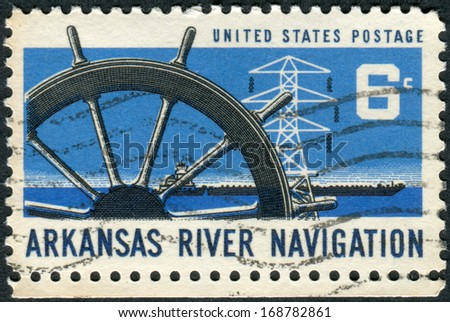 USA - CIRCA 1968: Postage stamp printed in USA, dedicated to the Opening of the Arkansas River to commercial navigation, shows Ship\'s Wheel, Power Transmission Tower & Barge, circa 1968
