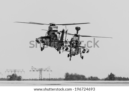 BERLIN, GERMANY - MAY 22, 2014: A joint demonstration flight of a pair of attacking helicopters Eurocopter Tiger. German Army and French Army. Black and White. Exhibition ILA Berlin Air Show 2014