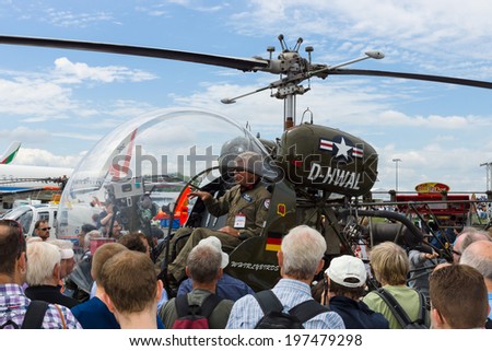 BERLIN, GERMANY - MAY 24, 2014: Pilot and multipurpose light helicopter Bell 47. US Navy. Exhibition ILA Berlin Air Show 2014