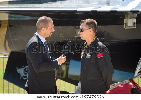 BERLIN, GERMANY - MAY 22, 2014: A journalist interviews a pilot of an F-16 Fighting Falcon. Turkish Air Force. Exhibition ILA Berlin Air Show 2014